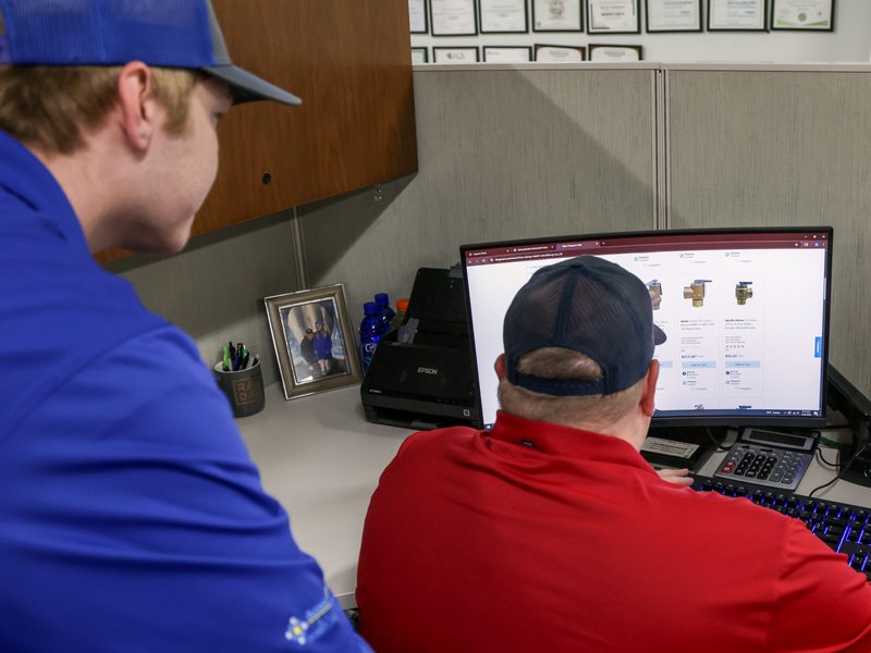 Staff managing access settings at a workstation