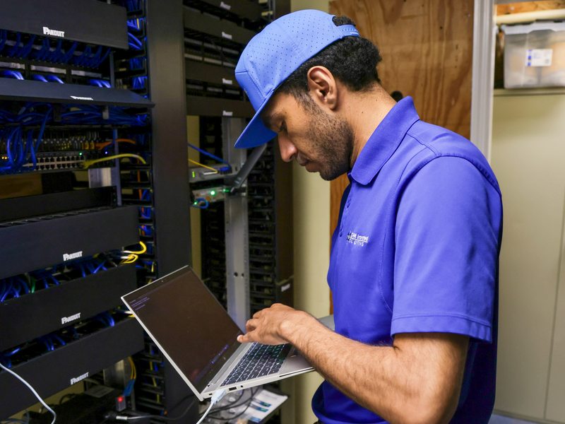 Technician managing backups at a network rack