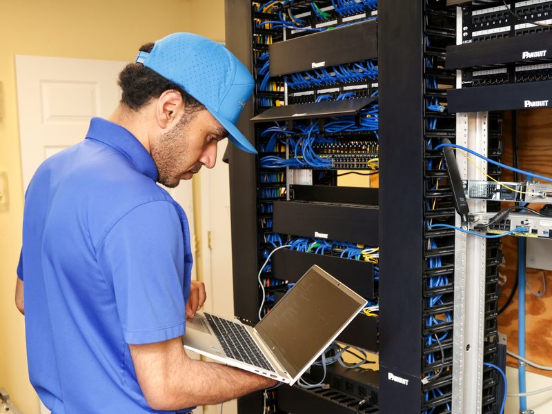 Technician at dense patch panels managing offsite copies