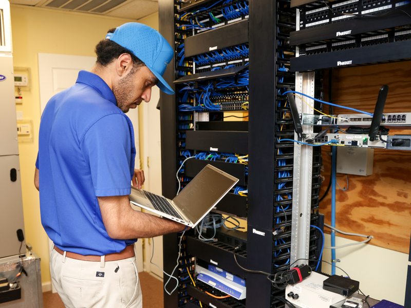 Technician restoring service at a structured cabling rack
