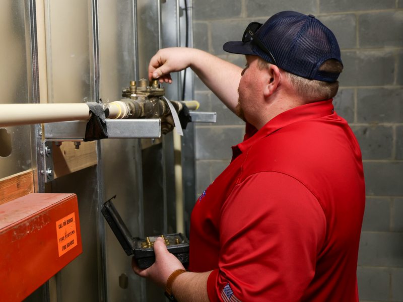 Technician servicing a backflow preventer