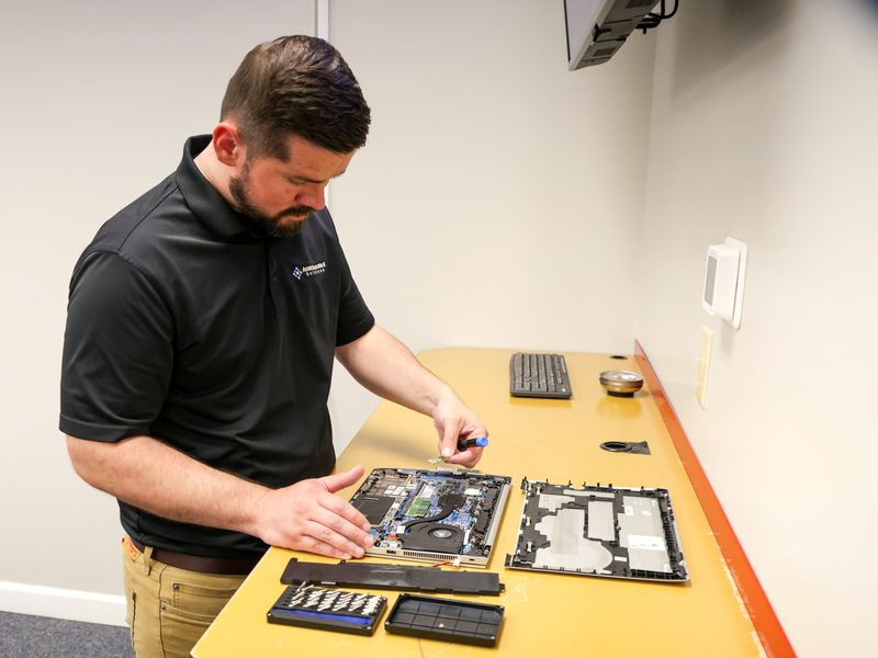Technician servicing a company laptop