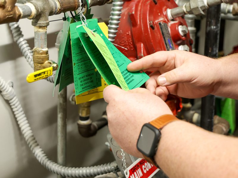 Hands flipping through inspection tags