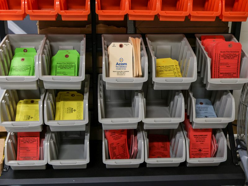 Bins of color-coded fire inspection tags