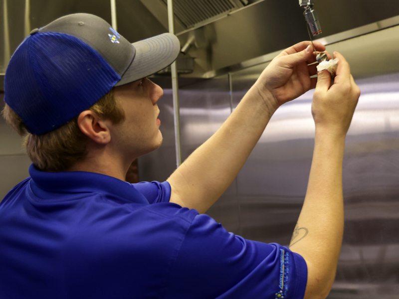 Technician inspecting a nozzle and link up close