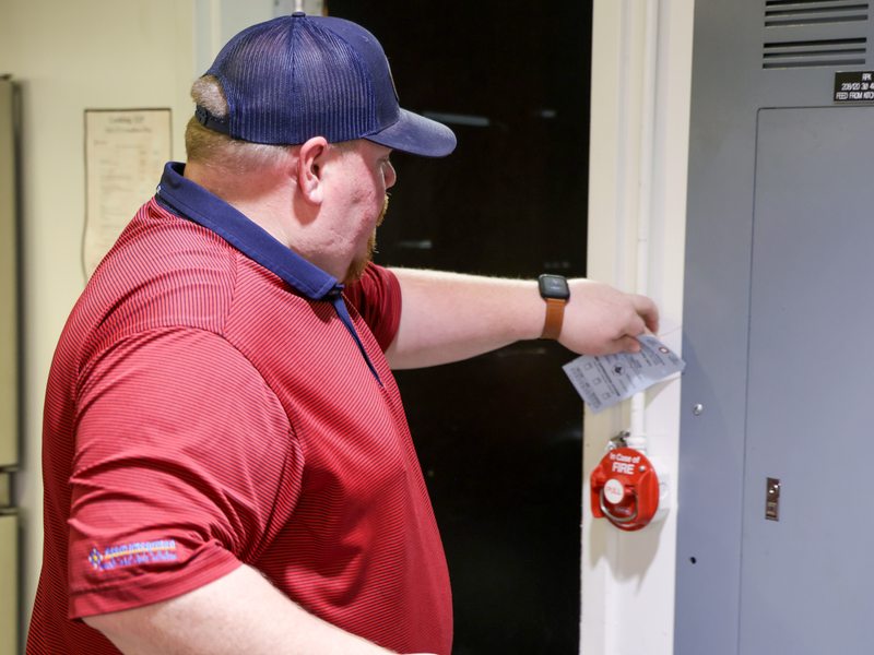 Technician tagging the system near the pull station