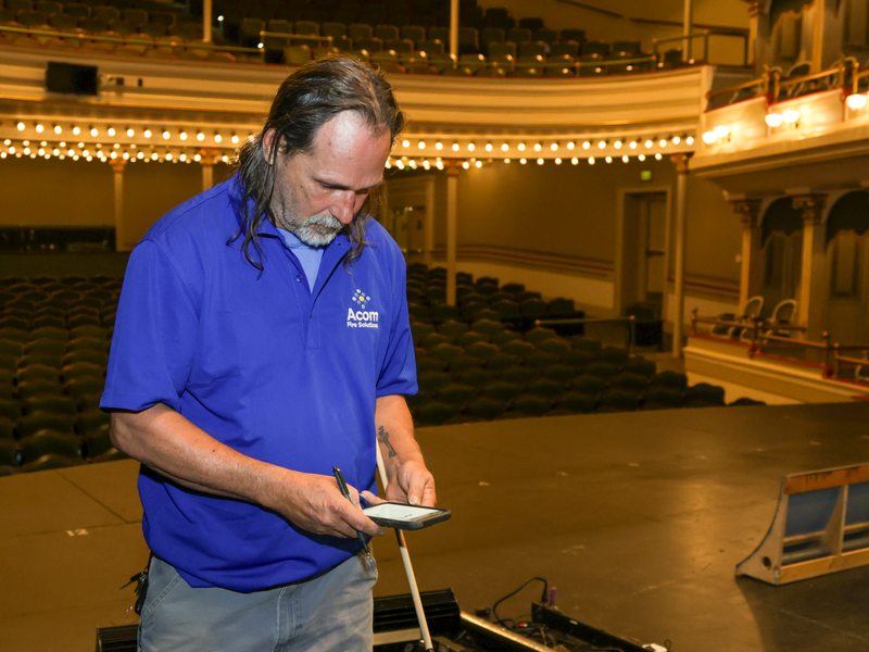 Technician logging results on a phone