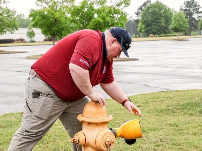 Technician inspecting the hydrant with diffuser attached