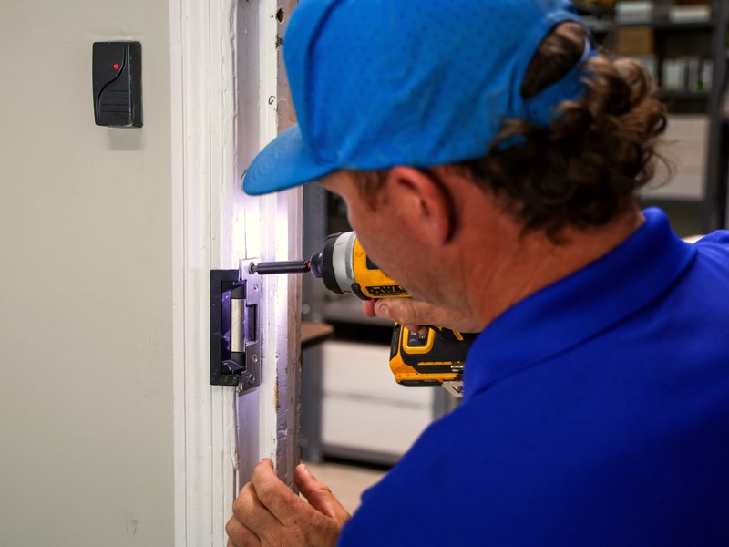 Acom technician securing a commercial door opening