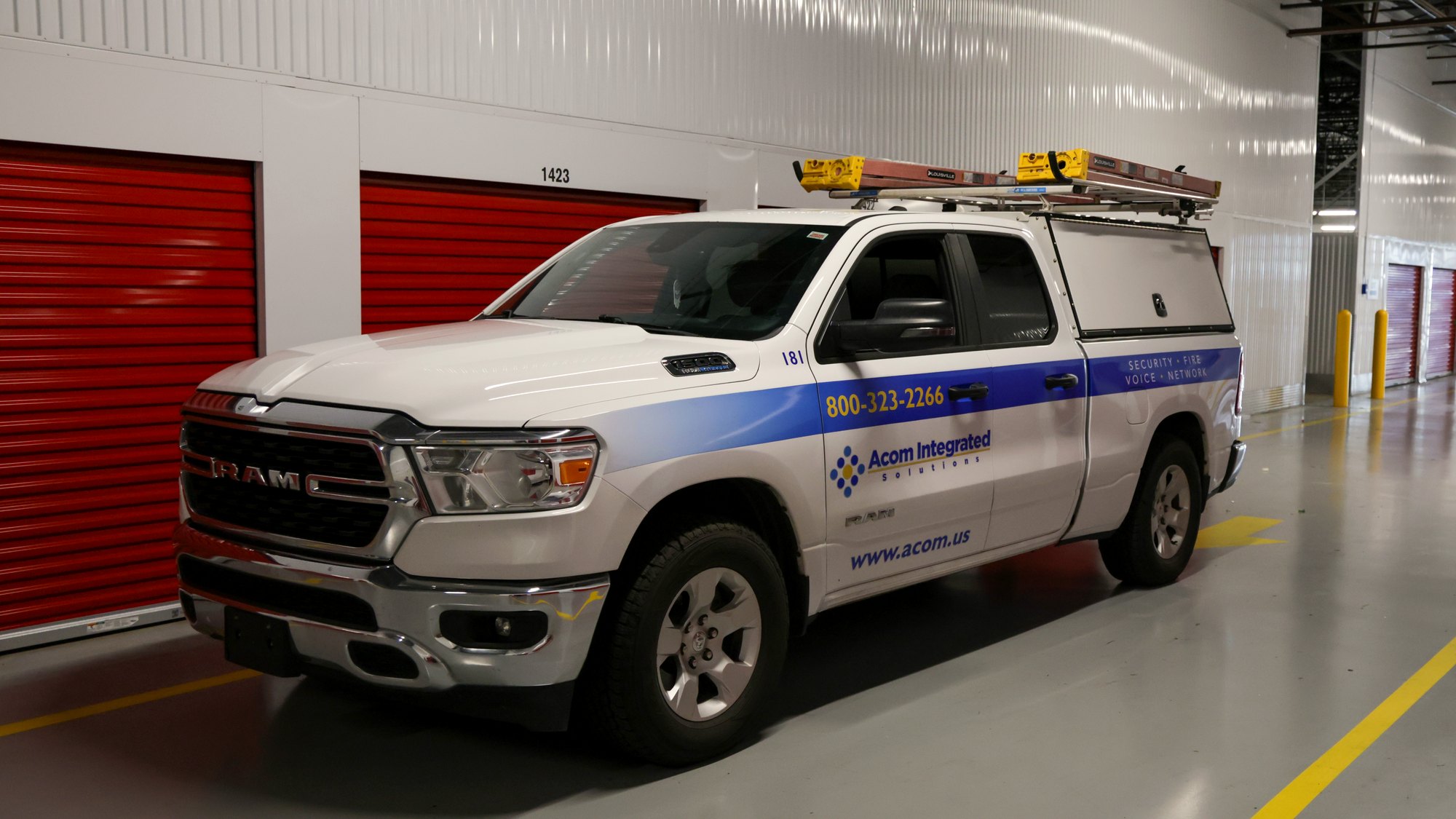 acom-mfg-hero-facility Acom Integrated Solutions service truck parked inside a commercial facility