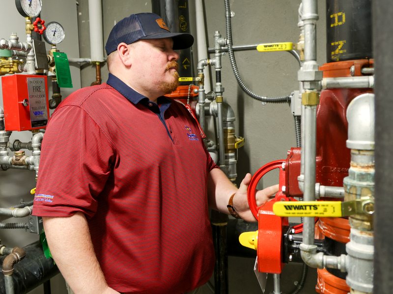 Technician at the sprinkler riser control valves