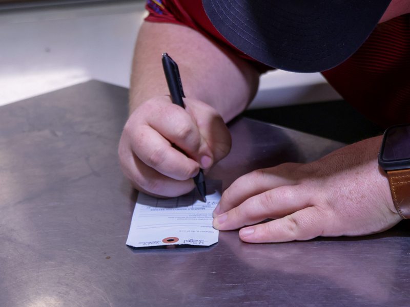 Technician filling out the inspection tag