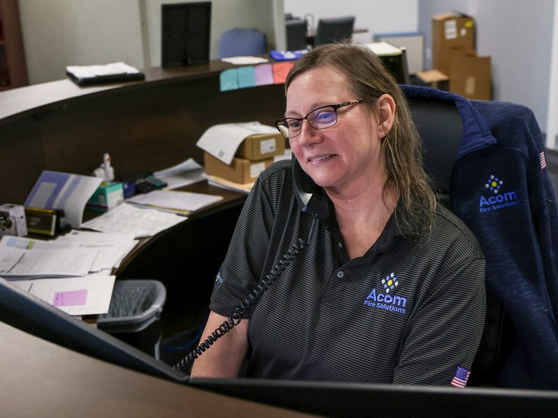 Front desk staffer handling calls and messages