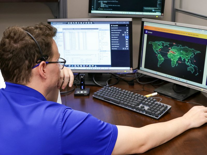 IT staff monitoring a cyber threat map