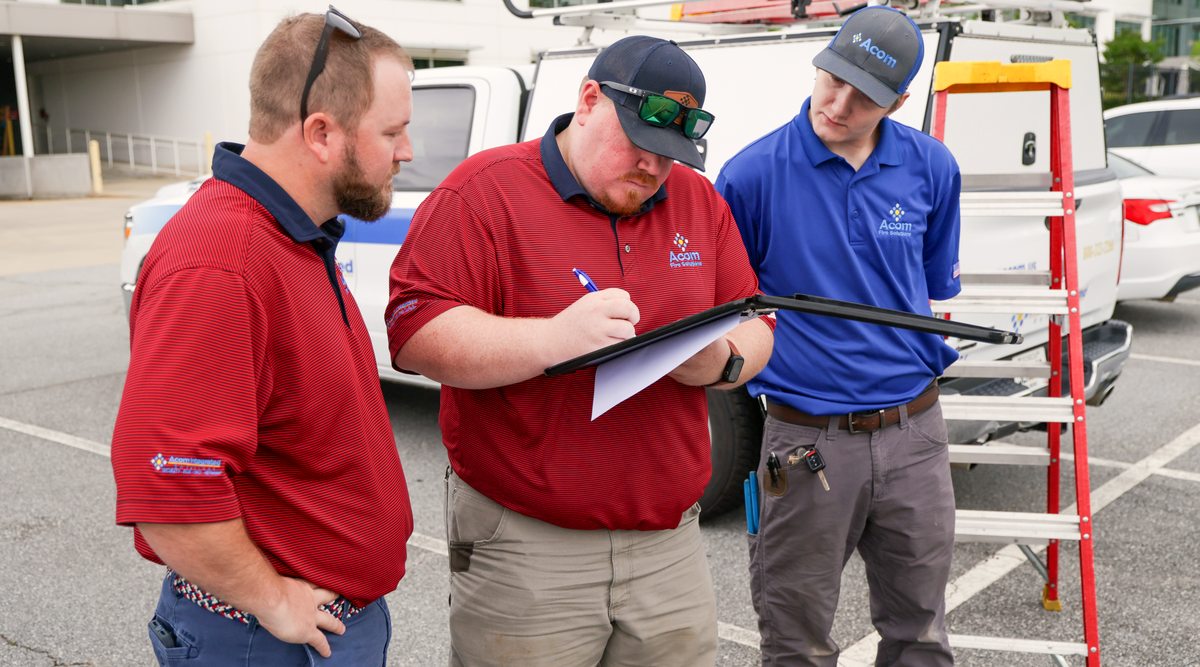 Team reviewing the plan beside the service truck