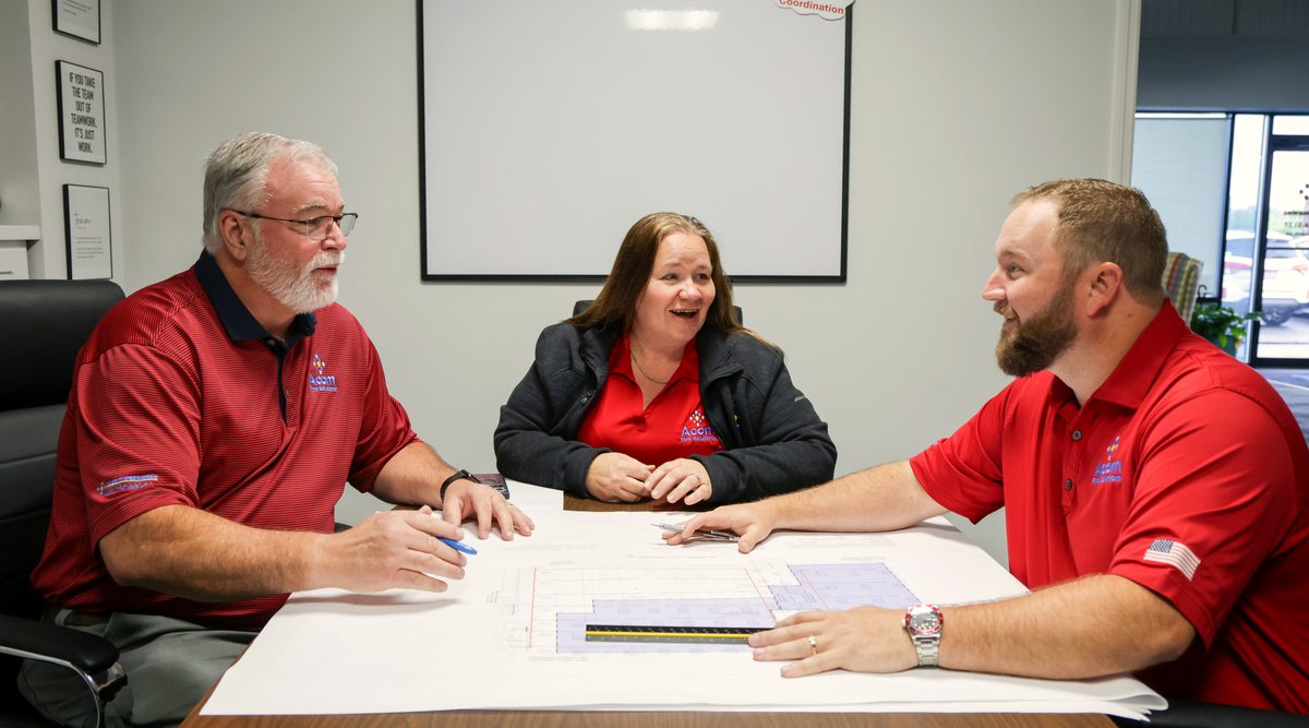Smiling Acom team reviewing the plan together