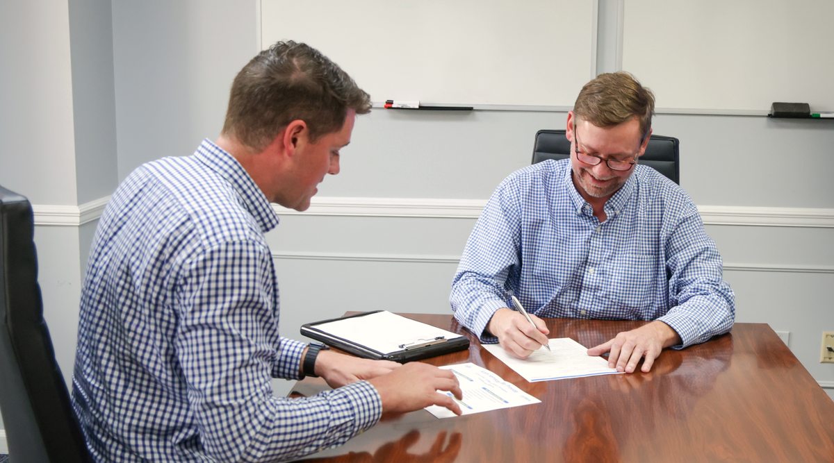 Business owner signing with confidence